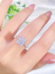 Close-up of S925 sterling silver ring with radiant cushion cut gemstone on hand