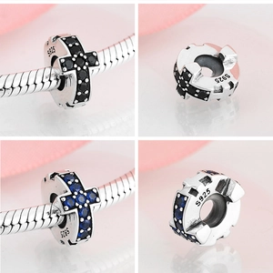 Macro detail of S925 sterling silver cross charms with black and blue zircon stones