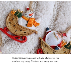 Macro shot of resin Christmas ornaments with snowman and Santa details and jute rope