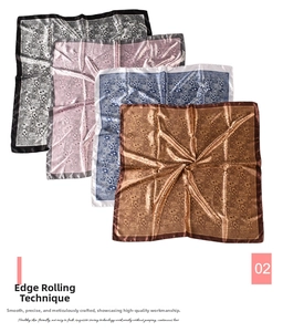 Detailed view of paisley satin square scarves with rolled edges in multiple colors