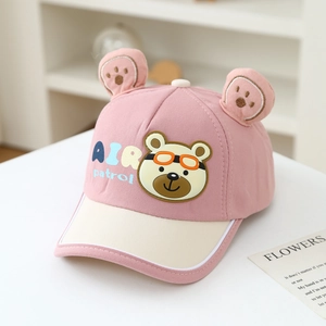 Detailed close-up of pink bear ears with footprint embroidery on child's baseball cap