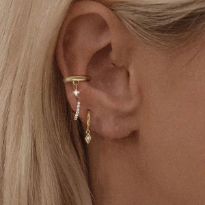 Close-up of gold S925 sterling silver hoop earrings set with star and diamond pendants