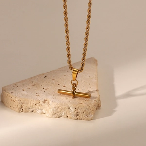 Detailed macro view of 18K gold-plated twisted rope chain with a minimalist T-bar pendant