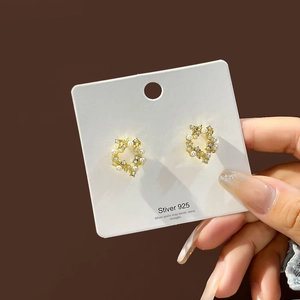 Detail view of S925 silver needle pearl flower earrings with sparkling rhinestones