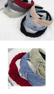 Detail of wide quilted fabric headband with cross knot design and soft sponge padding