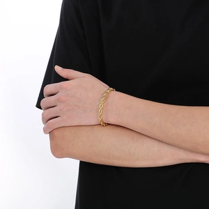 Macro detail of 18K gold plated stainless steel twist rope chain bracelet on wrist