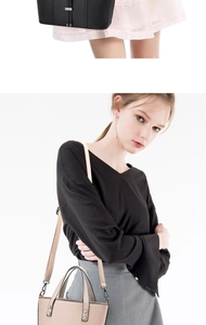 Detail of elegant PU leather handbags in black and beige with metal hardware