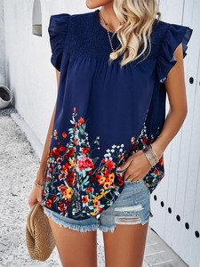 Close-up of navy blue sleeveless top with floral print and ruffle sleeve detail