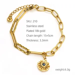 Detail of 18k gold plated stainless steel paperclip chain bracelet with starburst pendant