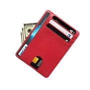 Detail of red textured leather passport holder featuring multiple card slots and cash pocket