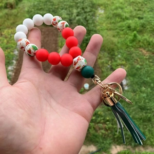 Close-up of Christmas silicone bead keychain with green tassel and snowman beads