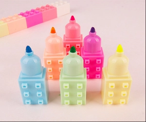 Close-up of six colorful building block highlighters in stackable castle design
