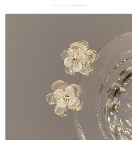 Close-up of elegant camellia hair clips with milky white petals and sparkly crystal centers