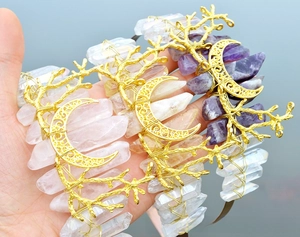 Detail of bohemian crowns with raw quartz crystals and golden crescent moon branches