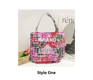 Close-up of red canvas tote bag with Milano cathedral print and white rope handles
