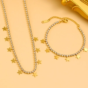 Macro shot of gold star necklace and bracelet set with sparkling cubic zirconia inlay