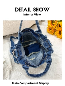 Detail view of denim shoulder bag main compartment with black lining and zip pocket