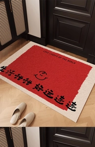 Detail of red and white welcome mat with Love Lights Up The World text and smiley face