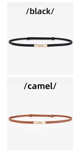 Detail view of black and camel leather belts with polished light gold rectangular buckles