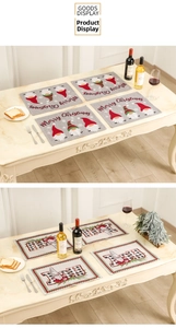Christmas placemats with gnomes and JOY letters on marble tabletop setting
