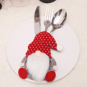 Christmas gnome cutlery holder on white plate with red polka dot hat and white beard