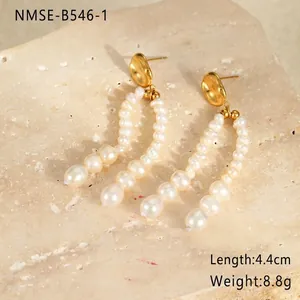 Detail view of pearl drop earrings with 4.4cm length and 8.8g weight on stone background