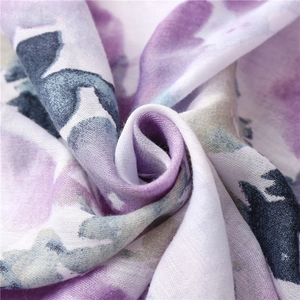 Close-up of soft linen-blend fabric with purple and blue watercolor floral ink patterns
