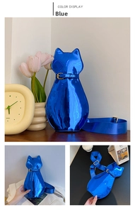 Detail of royal blue patent leather cat-shaped shoulder bag with glossy finish and cat ears
