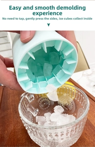 Squeezing mint green silicone cylinder ice mold to release small cubes into a glass cup