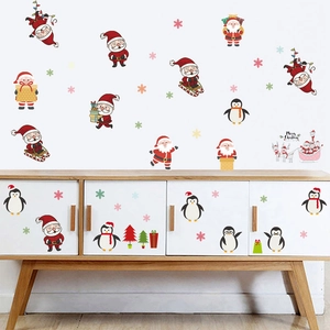 Cartoon Christmas wall stickers with Santa, penguin and Merry Christmas lettering on white wall