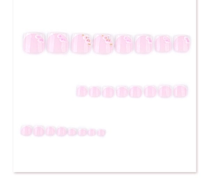 Detail of pink French press-on toenails with floral patterns and pearl embellishments