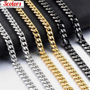 Detailed view of Cuban link chains in silver, gold and black stainless steel finishes