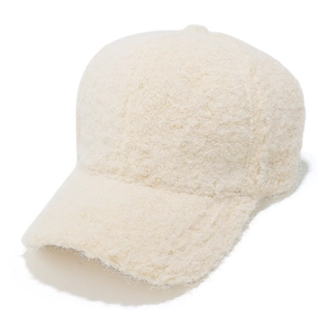 Close-up of fluffy cream faux fur baseball cap featuring soft sherpa fleece texture