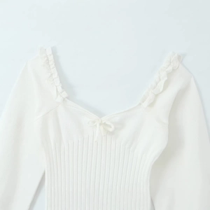 White ribbed knit long sleeve top with square sweetheart neckline and ribbon bow