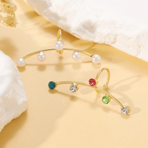 Detailed shot of gold fringe earrings featuring pearls and colorful zircon crystals