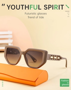 Detail of trendy cat-eye sunglasses featuring hollow-out temples and brown gradient lenses