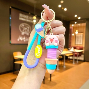 Cute pig ice cream keychain with pink spring strap held in hand for bag decoration