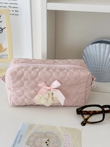 Detail of pink quilted heart makeup bag with lace trim and sweet ribbon bow