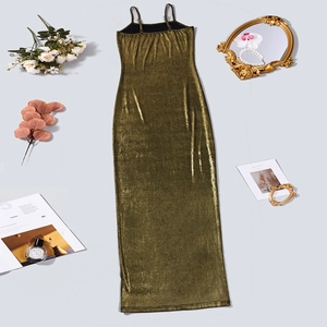 Detail of metallic gold-green velvet maxi dress with thin spaghetti straps and elegant texture