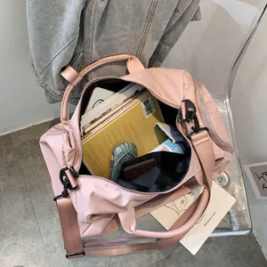 Spacious pink travel bag interior showing large capacity for books and personal items