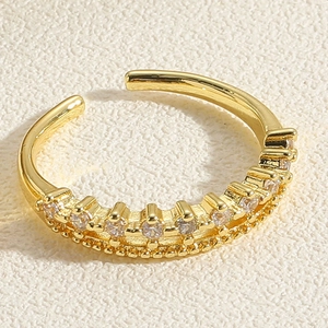 Close-up of gold adjustable ring featuring pavé-set zircons and milgrain detailing