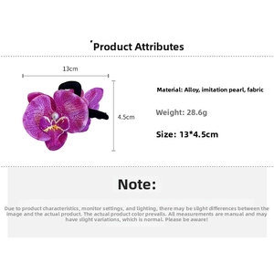 Close-up of purple orchid hair claw with white pearl detail, sized 13cm by 4.5cm