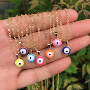 Handheld vintage gold necklaces featuring colorful teardrop evil eye enamel pendants