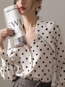 Close-up of elegant polka dot shirt with vintage pointed collar and lantern sleeves
