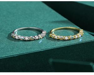 Detail of s925 silver rings with marquise opal and zircon on dark green display