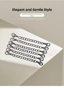 Close-up of six gunmetal alloy necklace extenders with dual lobster clasps for DIY jewelry