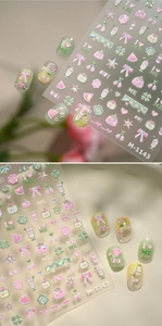 3D embossed nail stickers M-1143 featuring bows and cherries applied on clear tips