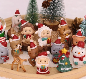 Detailed view of miniature resin Christmas figurines including Santa and cute animals
