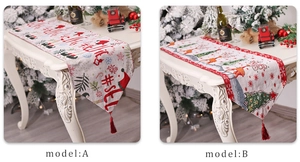 Close-up of red Christmas table runner with festive elk patterns and fringe tassels