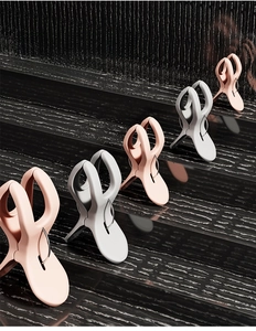 Pink and grey heavy-duty plastic laundry clips with metal rings for windproof drying